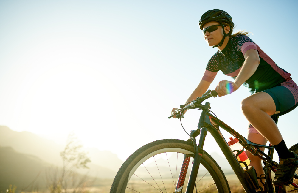 Shot of a sporty young woman out cycling on a country road